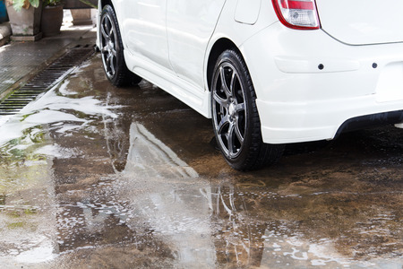 White car washing at the car wash shop to clean up dirt and keep the health of the driver and passengers.の写真素材
