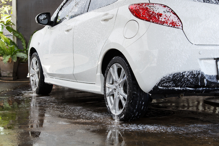White car washing at the car wash shop to clean up dirt and keep the health of the driver and passengers.の写真素材