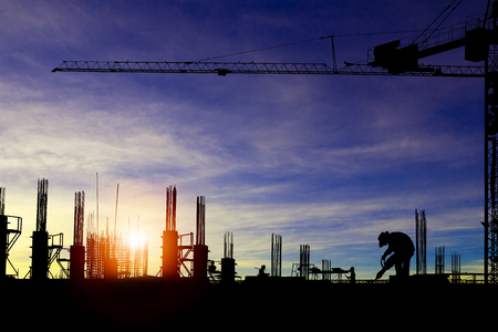 Silhouette images of construction sites are underway and workers are working.の写真素材
