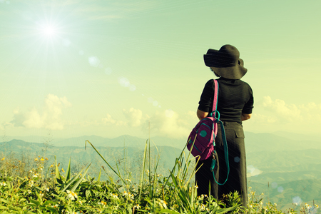 Tourist woman relaxing at mountain view landscapeの写真素材