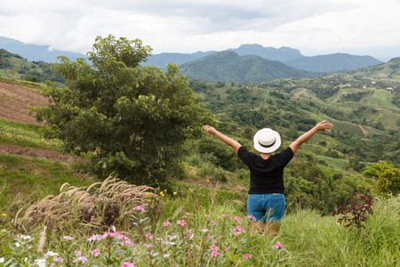 Tourist woman relaxing at mountain view landscape on daytimeの写真素材
