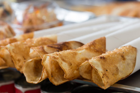 Thai street food of merchant making delicious hot roti for customers-6