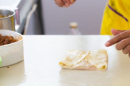 Thai street food of merchant making delicious hot roti for customersの写真素材