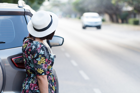Woman parking car on the side of the road. For assistance repair by qualified car mechanic.の写真素材