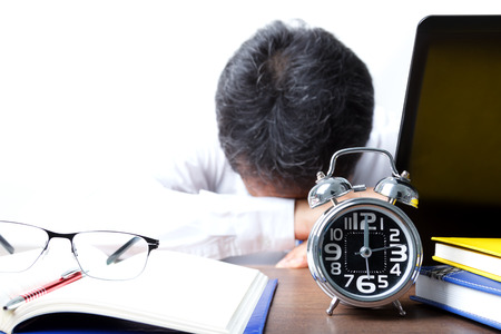 Businessman in stressful mood on midnight time, the concept represents the busy work of the office and stress.の写真素材