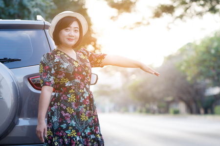 Woman parking car on the side of the road. For assistance repair by qualified car mechanic.の写真素材