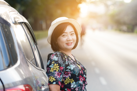 Woman parking car on the side of the road. For assistance repair by qualified car mechanic.の写真素材