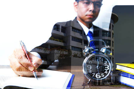 Double exposure of businessman working up to midnight, concept of busy and hard workの写真素材