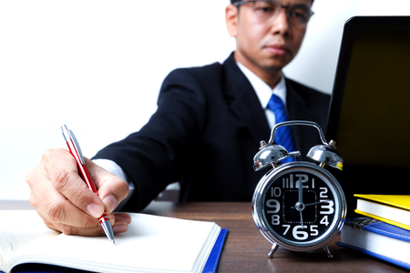 Businessman working up to midnight, concept of busy and hard workの写真素材