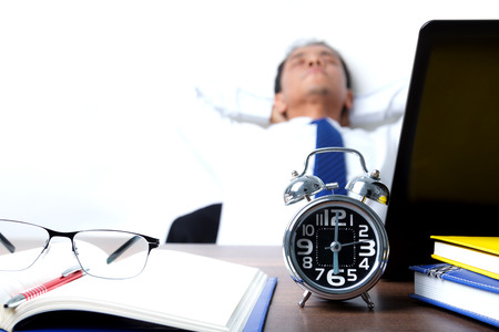 Businessman in stressful mood on wakeup time, the concept represents the busy work of the office and stress.の写真素材