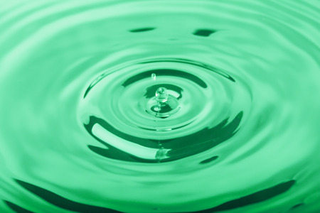 Macro shot of water splash on blue backgroundの写真素材