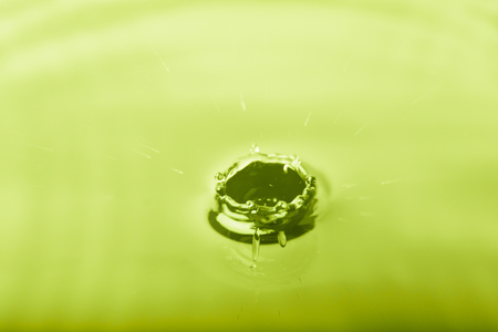 Macro shot of water splash on blue backgroundの写真素材