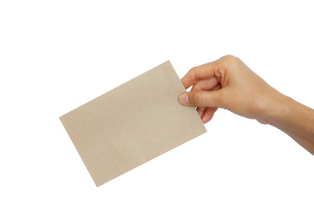 Woman hand holding brown envelope isolated on black backgroundの写真素材