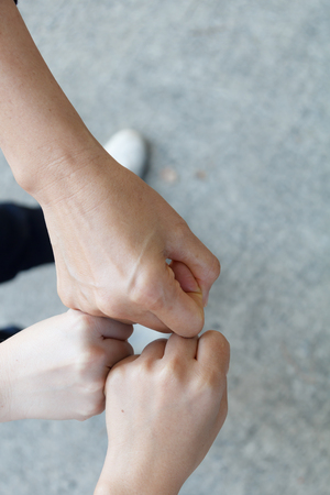 Close up top view of female hand putting together, concept for success signの写真素材