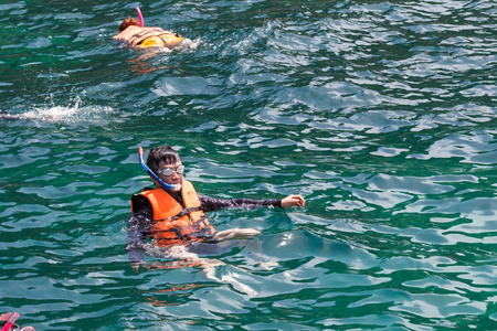 Asian man  snorkeling with relaxed and happy way at sea beach vacationの写真素材