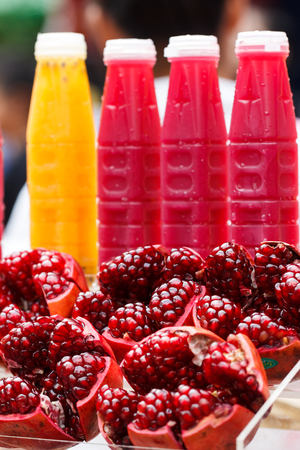 Pomegranate juice and fresh passion fruit juice sold in Thailand street marketの写真素材