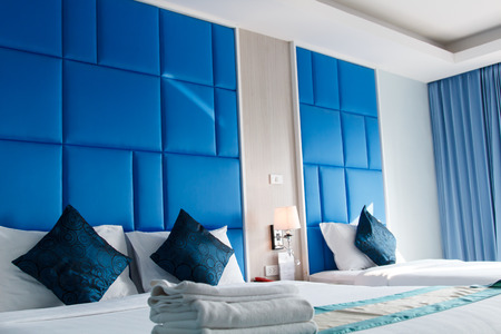 Blue color bed room interior with white towel and blue pillow on bedの写真素材