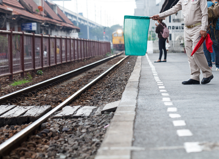 Officials were waving green flags as a sign of safety while the train was running into the landing zone.の写真素材