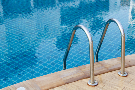 Grab bars ladder in blue the swimming poolの写真素材
