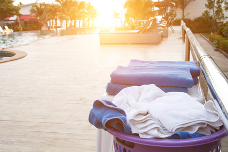 The towel provided at the public swimming pool with people in backの写真素材