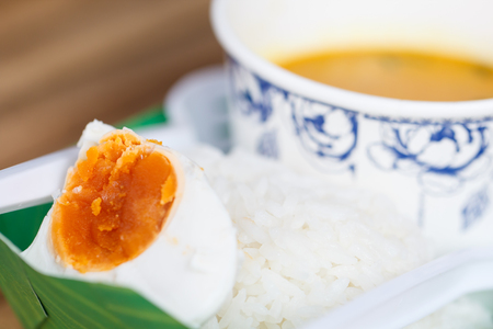 Salted egg with curry and rice in street foodの写真素材