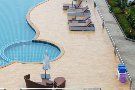 Top view of Swimming pool with blue water beach chair and umbellaの写真素材
