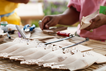 Traditional crafts wooden boat with craftsman in backの写真素材