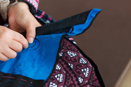 The hand craft of woman embroidered pictures with needle and thread.