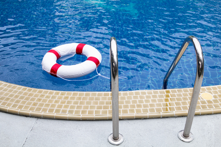 Life ring and stair in swimming pool with copy space.の写真素材