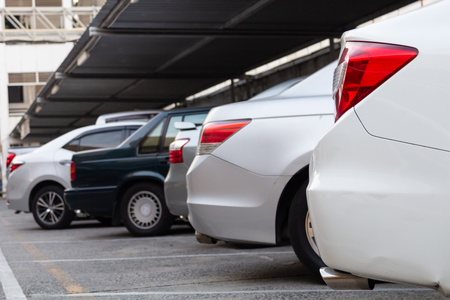 White car parked at outdoor parking line.の写真素材