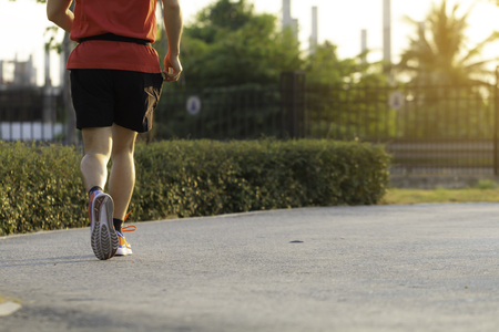 Sport background, Man runner's legs run on the street of public with copy space.の写真素材