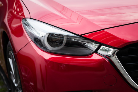 Closeup of headlight red car.の写真素材
