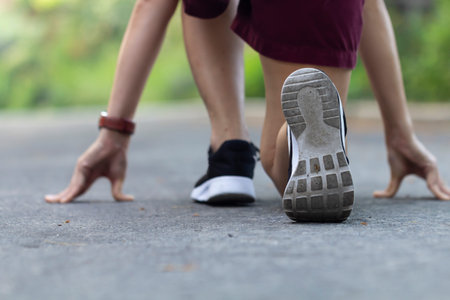 Athlete runner feet running on road in the park closeup on shoe, concept of startup business.
