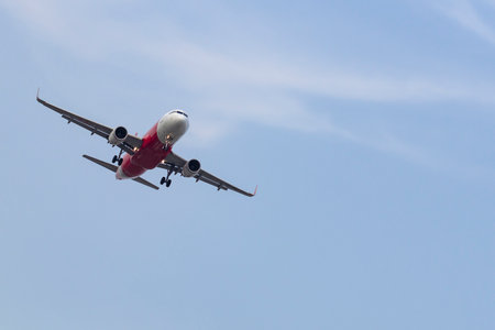 Commercial airplane flying with blue sky background.のeditorial素材