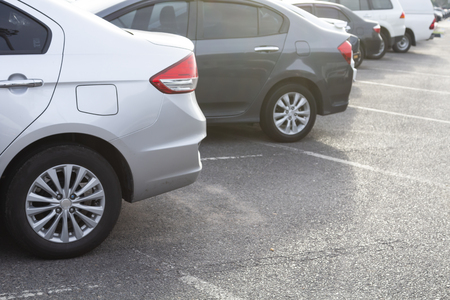 Side view of silver car parked in inside outdoor parking lot. Transportation concept.の写真素材