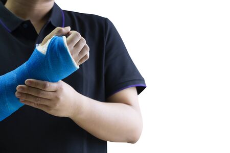 Close up man holding hand with blue bandage as arm injury concept. Isolated on white background.の写真素材
