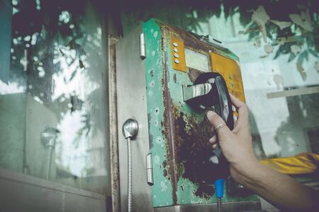 Vintage of hand holding public phone.の写真素材