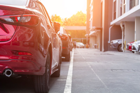 Red car parking in line and car running background.のeditorial素材