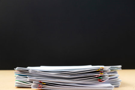Half of Stack of document paper with colorful paperclip place on wooden table, business concept...