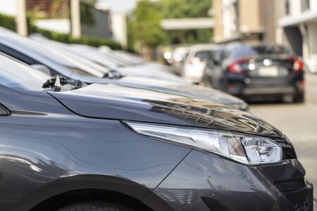 Close-up car parked in row neatly inside an outdoor parking lot.の写真素材