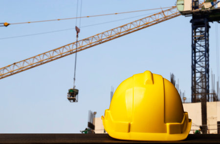 helmet in construction site and construction site worker background, safety first concept.