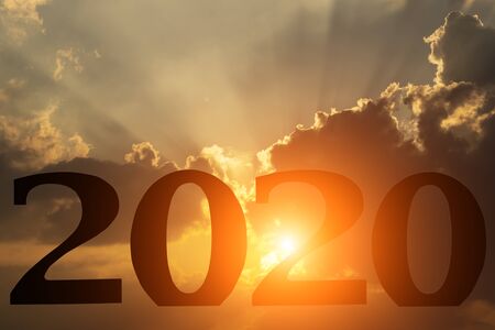 Happy New Year 2020. Creative text Happy New Year 2020 written with dramatic sunset background.の写真素材