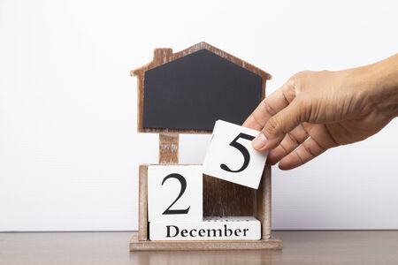 Hand pick up number of 25 December on white background, Christmas decoration day concept.の写真素材