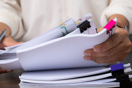 Male office workers holding documents on office desk, Stack of business paper.