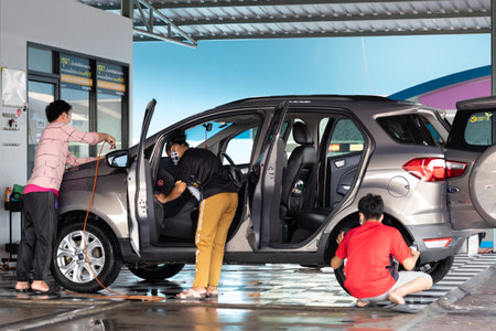 NONTHABURI, THAILAND - MARCH 22, 2020: Worker washing the SUV car at the local service car wash. Thailand on march 22, 2020.のeditorial素材