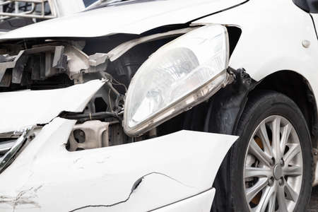 Close-up of front of white car get damaged by accident on the road. concept of road safetyの写真素材