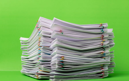 stack overload document report paper with paperclip place on green background, business and...