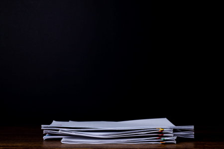 Stack document report paper on black background with copy space, business concept paperless used.