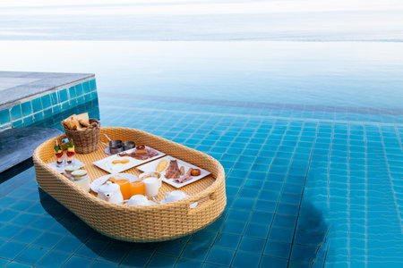 floating breakfast in the pool to Serving the tourists who are staying on holiday, the floating brrakfast is the key tourism symbol of hotels in Phuket, Thailand.の写真素材