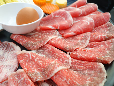 Fresh beef raw with vegetable and egg for Sukiyaki Japanese food shabu shabu.の写真素材